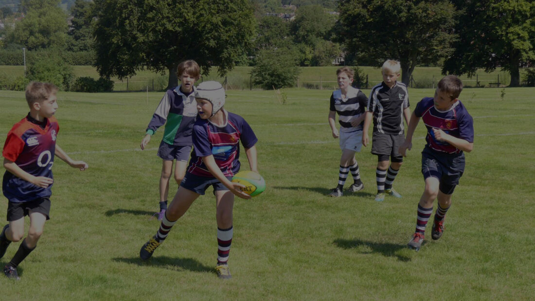 Young rugby players passing a ball